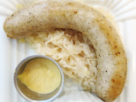 Sausage & Sauerkraut ($9.5): Classic Pork Thuringer Bratwurst served over warm sauerkraut, house mustard.