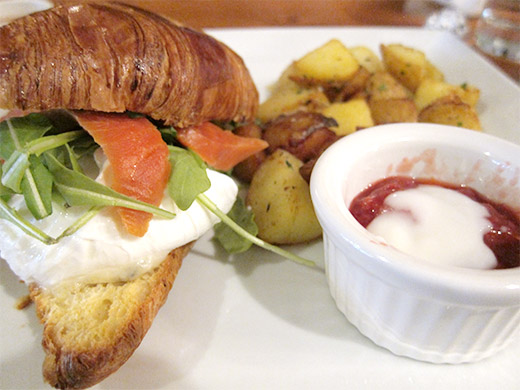 The restaurant's namesake dish, Catch 122 is house-cured salmon gravlax sandwiched between a croissant, topped with poached eggs, gorgonzola, arugula and served with yukon nugget potatoes and a berry compote.