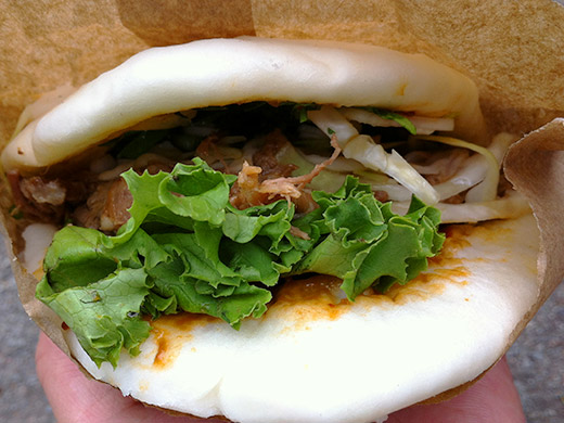 Le Tigre's Steamed Bun with BBQ Pulled Pork ($4.25) stuffed with cabbage slaw, cilantro, basil, and sweet chilli bean sauce.