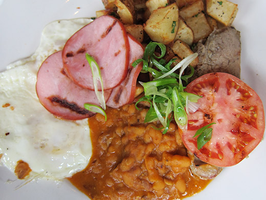 English Breakfast ($15) -- Two eggs any style. Served with grilled apple sage sausage, Fraser Valley back bacon, bourbon baked beans, roasted tomato, house cut hash browns with buttered multigrain toast.