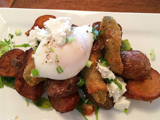 Deep fried panko-encrusted avocado with a single poached free-range egg ($7.50) served over truffle-lemon hashbrowns(+$1).