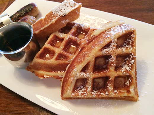 Belgian Waffles ($6.75) with melted butter and syrup + English Bangers (+$3).